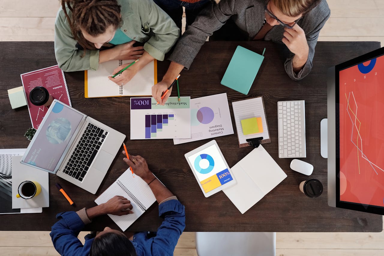 Overhead view of a diverse team collaborating on a project in a modern office setting.